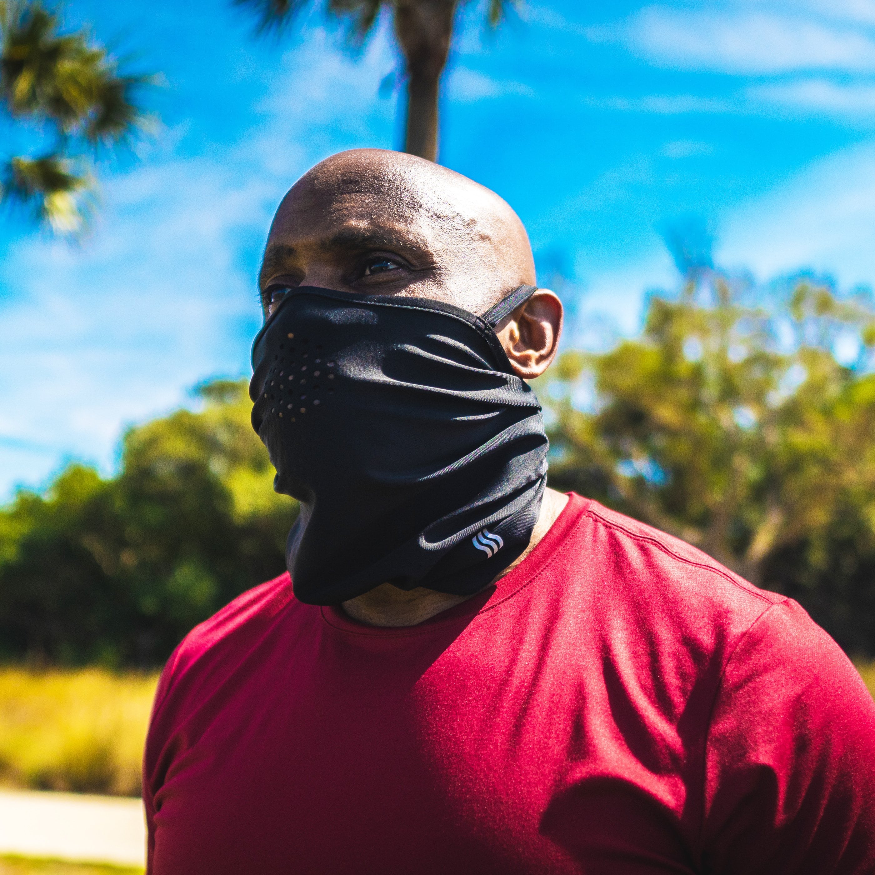 Athletic guy wearing our headband as a vented face mask while running.