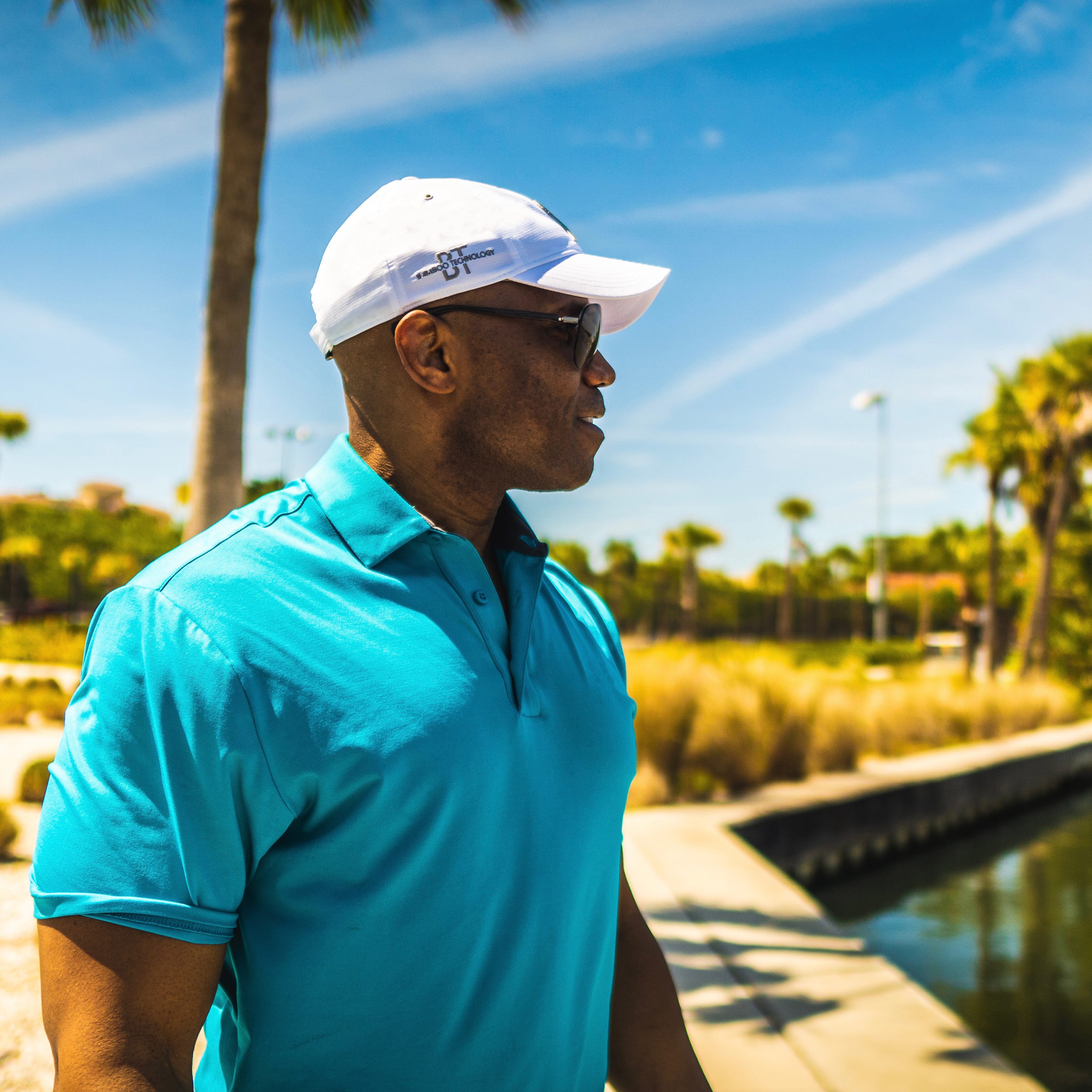 Men wearing his sweat wicking cap during a hot day.