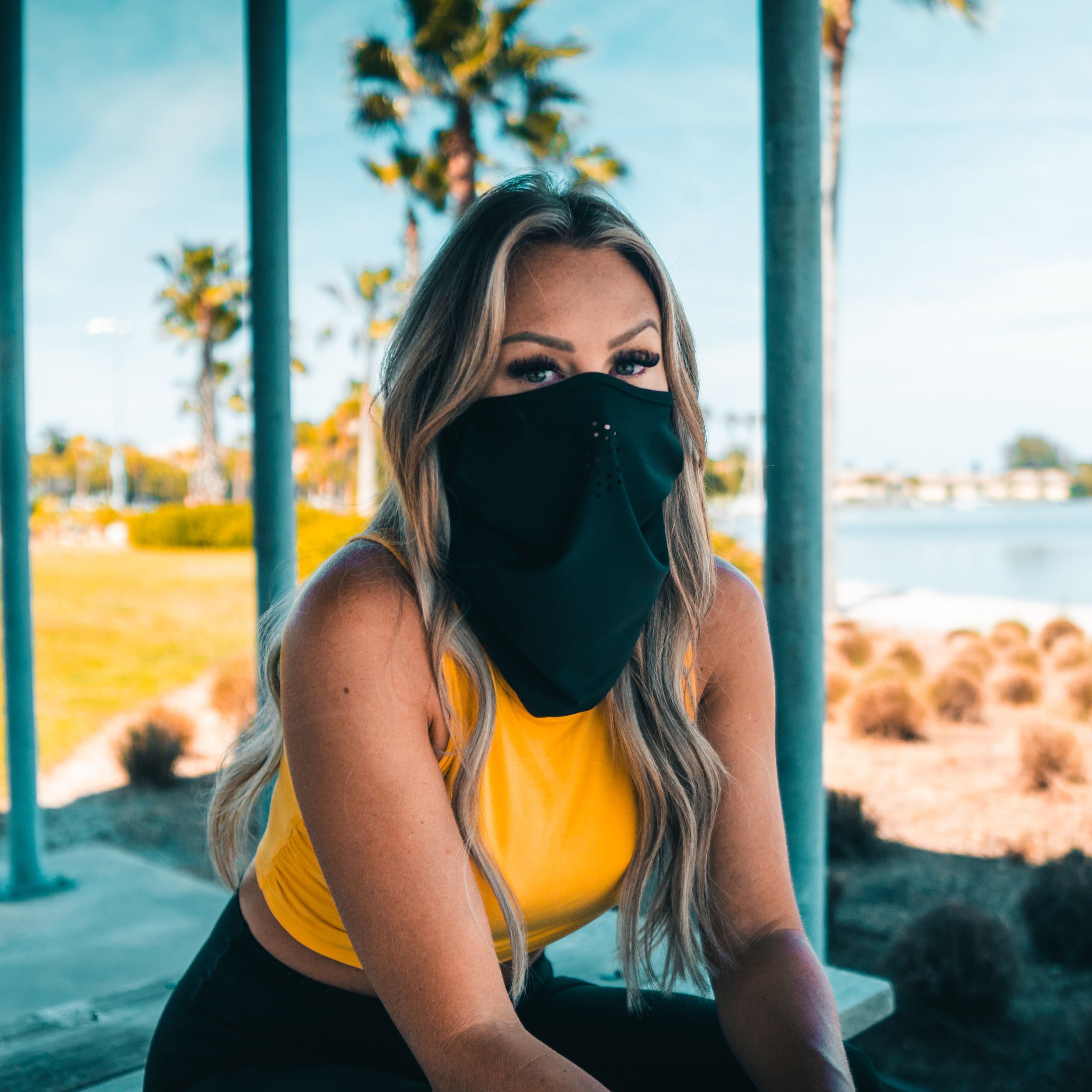 Women wearing a versatile headband that can be worn as a face mask.