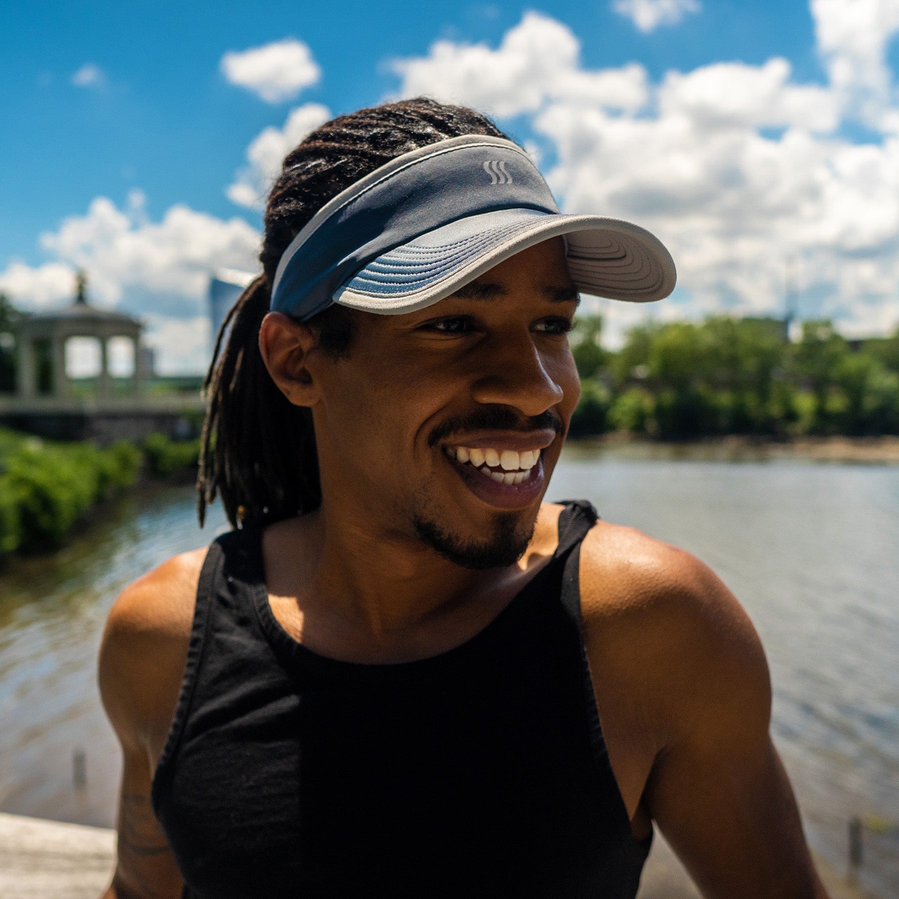 Man casually wearing a visor to stop sweat and the sun.