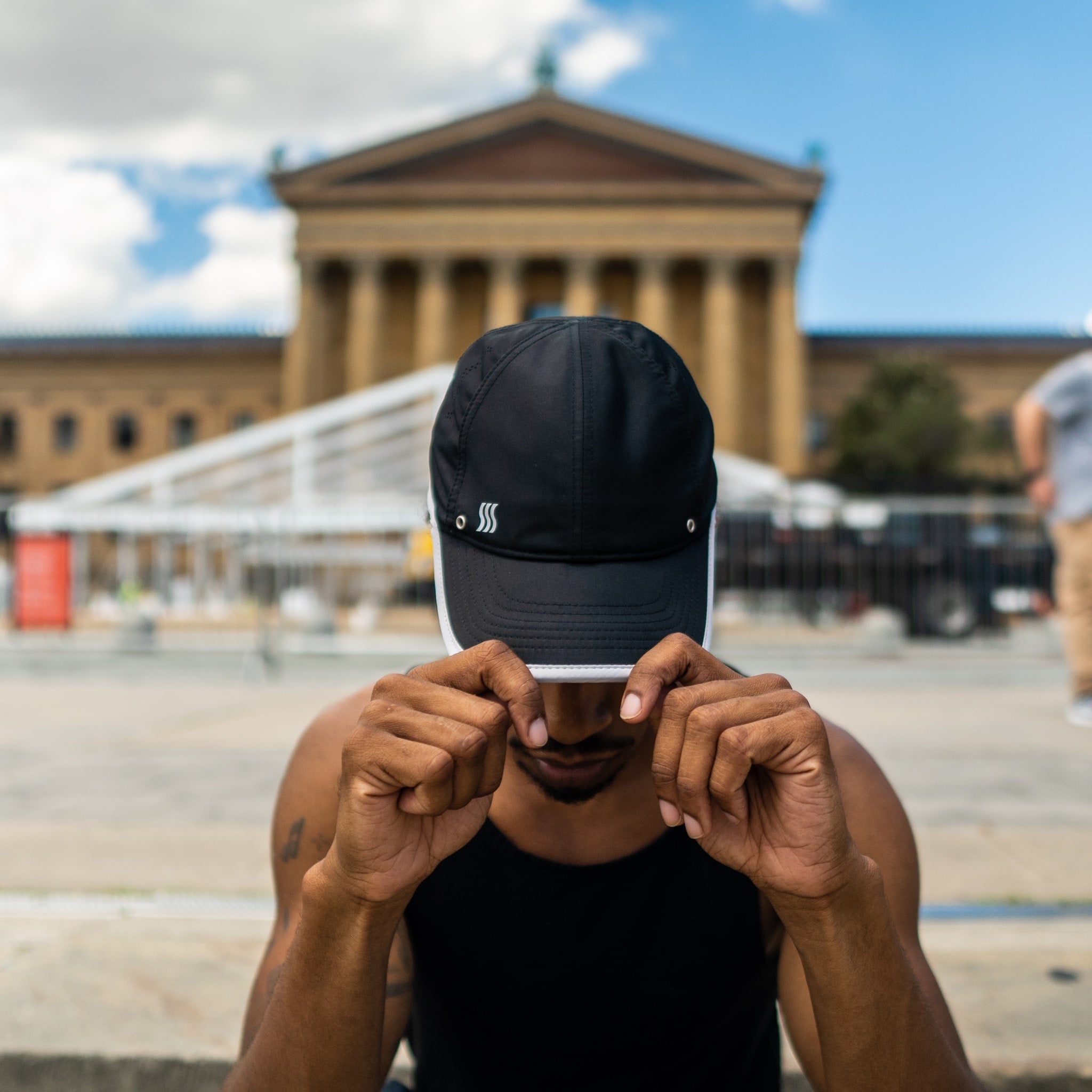 Guy running in a black featherweight hat.