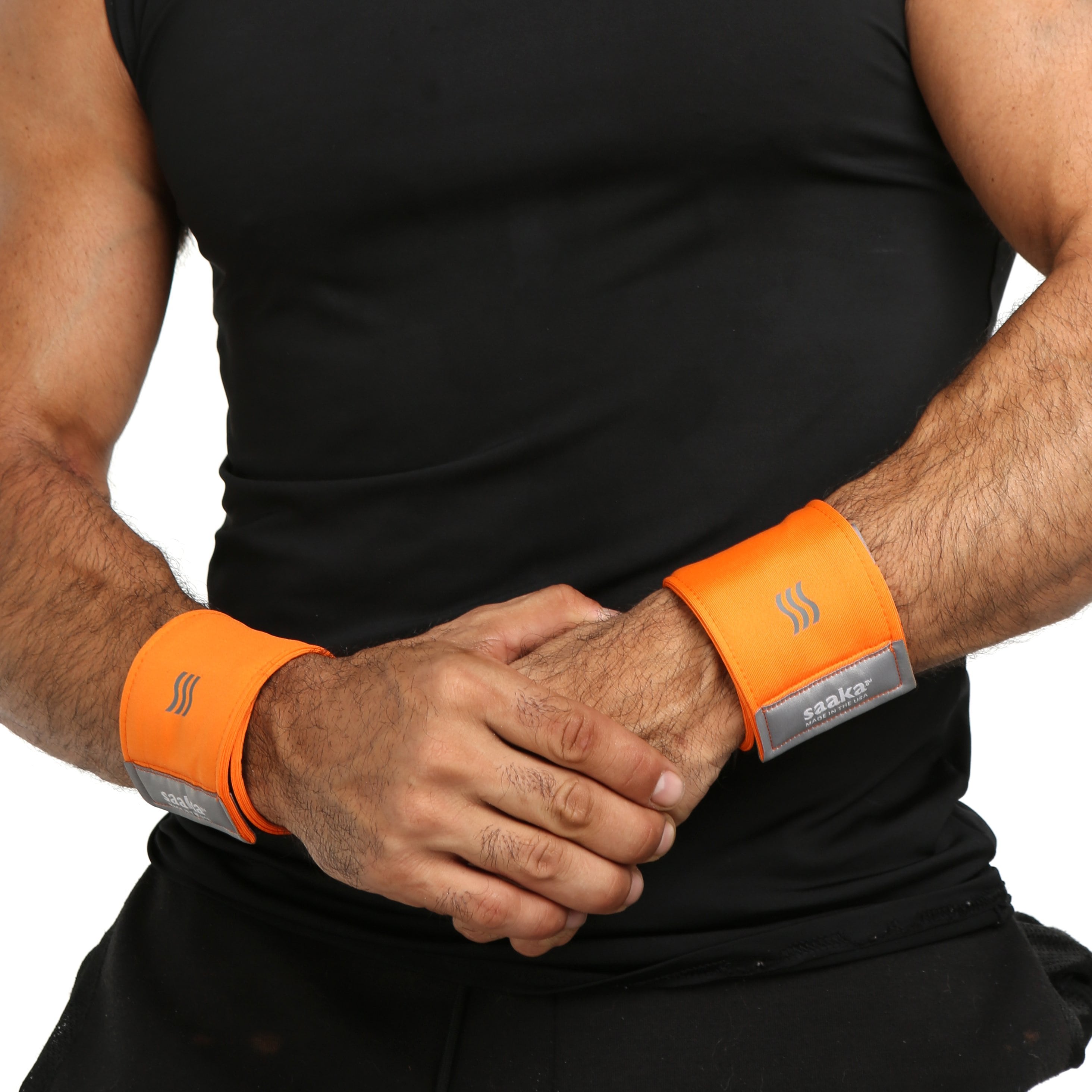 Man wearing a pair of orange performance wristbands for sweat.