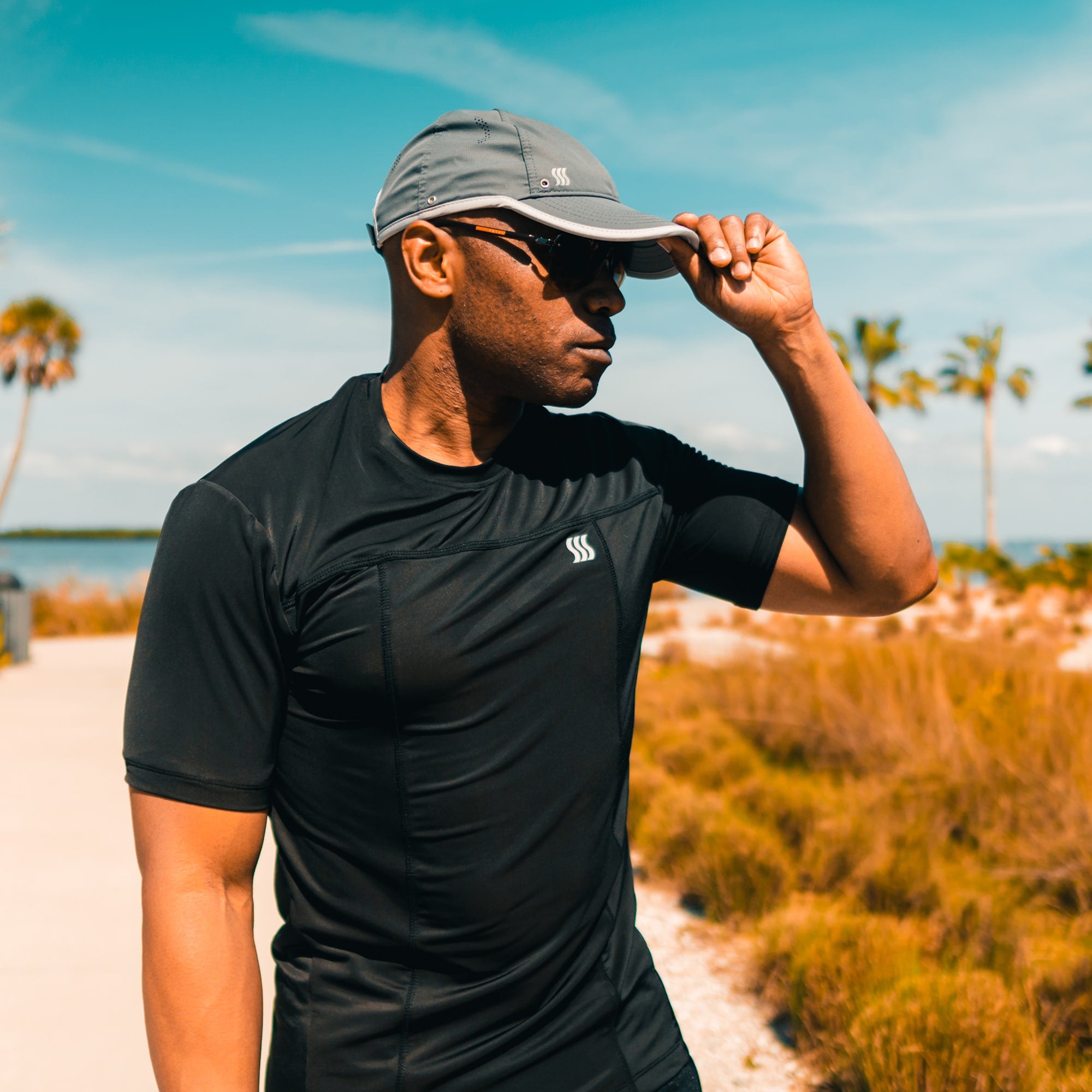 Guy wearing a sweat wicking hat while running. 