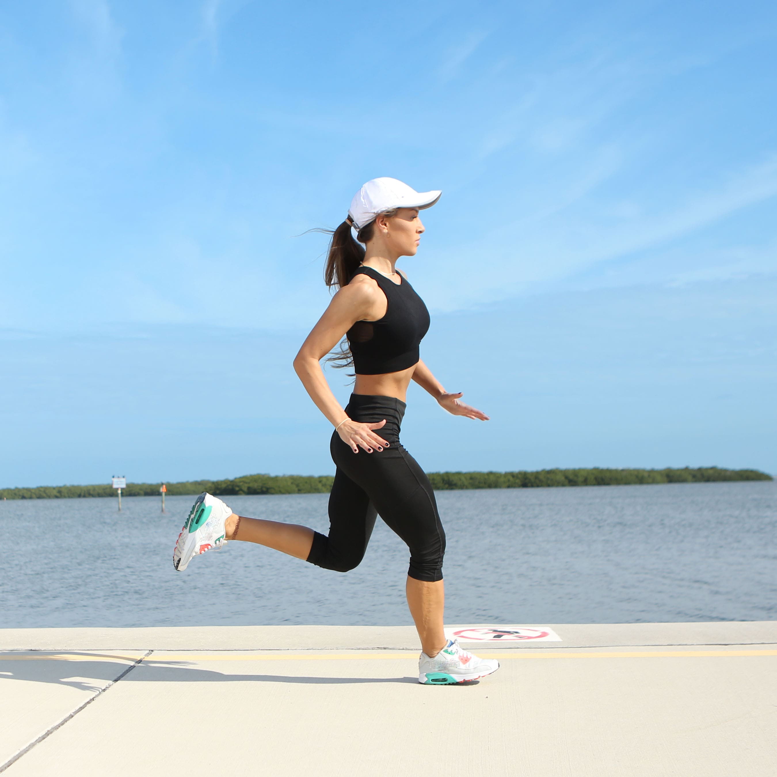 Girl running in a white lightweight hat
