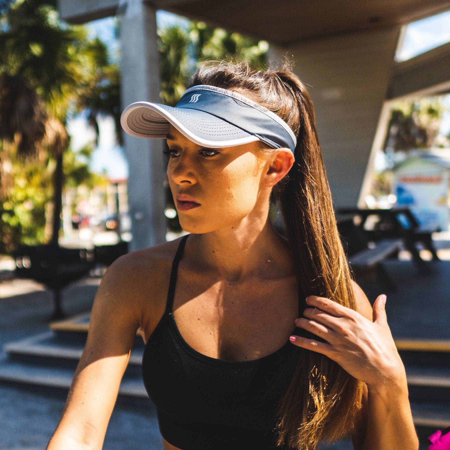 Women runner wearing a gray visor to help with the sun.